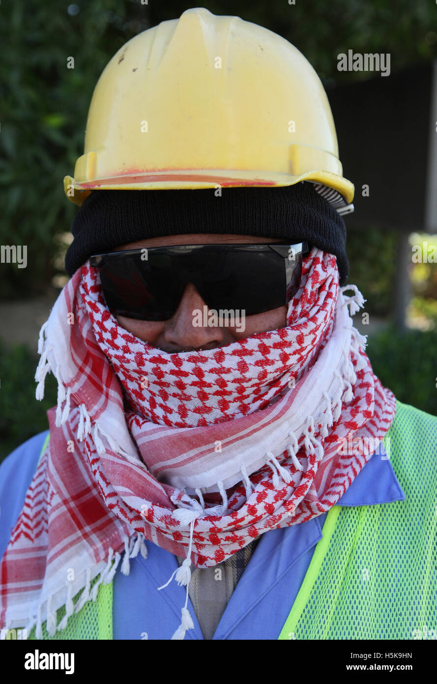 Construction worker wearing protective clothing, helmet and sunglasses