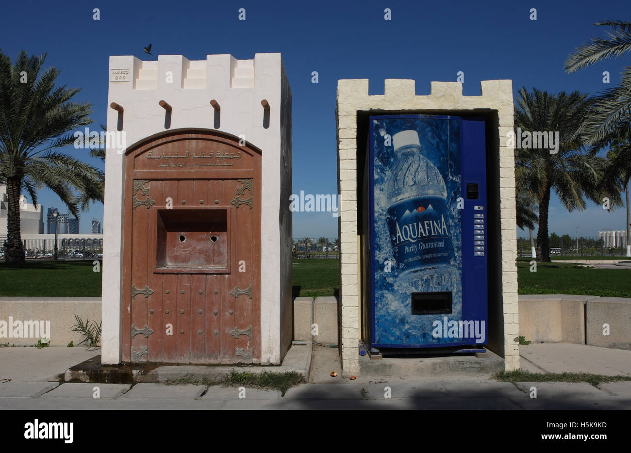 An old, not functioning potable water dispenser next to a modern mineral water dispenser, Doha, Qatar, Middle East Stock Photo