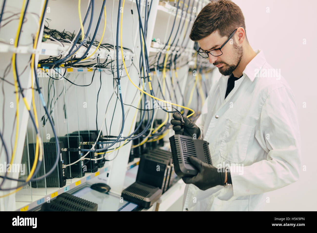 Network technician testing modems in factory Stock Photo Alamy