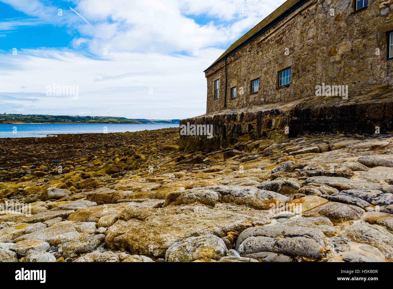 a low view of St. Michael's Mount cottages and sea shore in Cornwall