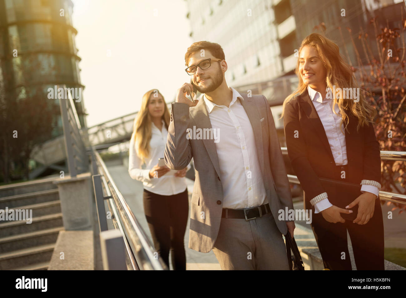 Business colleagues outdoors walking Stock Photo