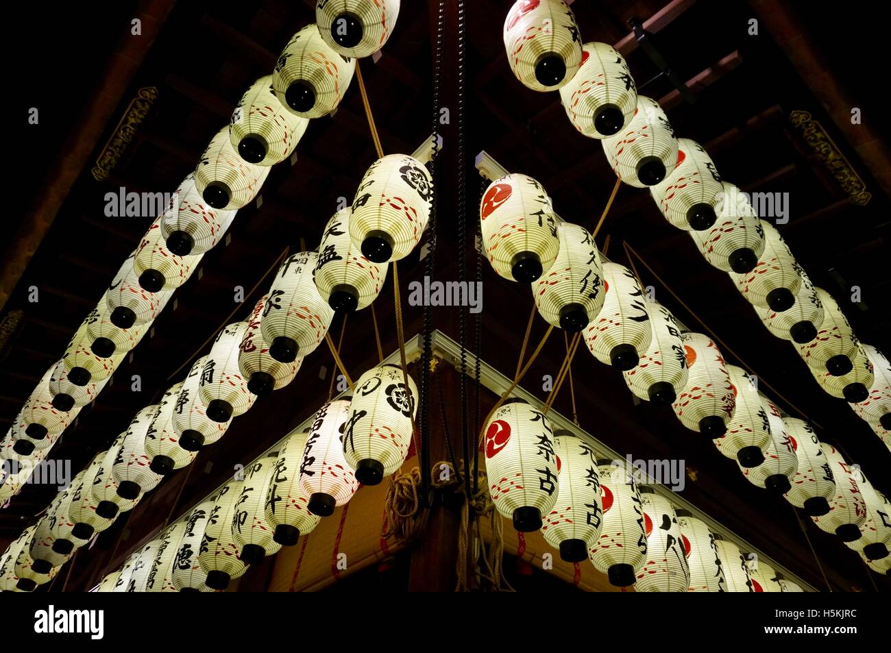 Lights at night, Japanese paper lanterns hanging in lines at a temple in Kyoto Stock Photo