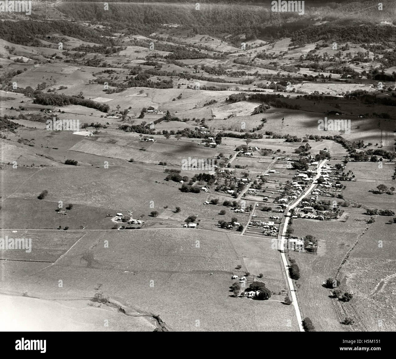 The 1936 aerial photograph of Jamberoo, South Coast, captures the region's landscape during a time of change. The photograph is part of the RAHS Adastra Aerial Survey Collection, offering a historical view of this area in the 1930s. Stock Photo