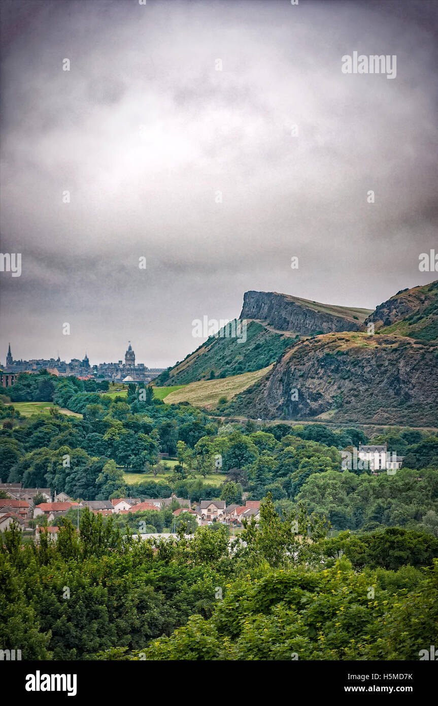 A gloomy view of Arthurs seat from Craigmillar Castle ruins with the Scottish capital city of Edinburgh away in the background. Stock Photo
