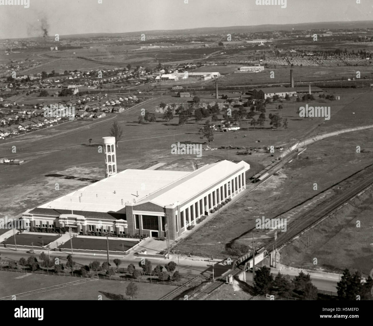 This image from the Adastra Aerial Survey Collection captures the Ford Motor Company factory on August 2, 1937, located near Homebush and Parramatta Road in Australia. It provides a historical view of the factory's operations during the early 20th century. Stock Photo