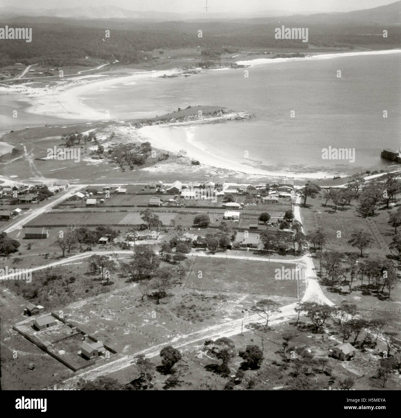An aerial photograph taken on November 17, 1937, showing Bermagui looking north. The image is part of the Adastra Aerial Survey Collection, capturing the coastal landscape from an elevated perspective. Stock Photo