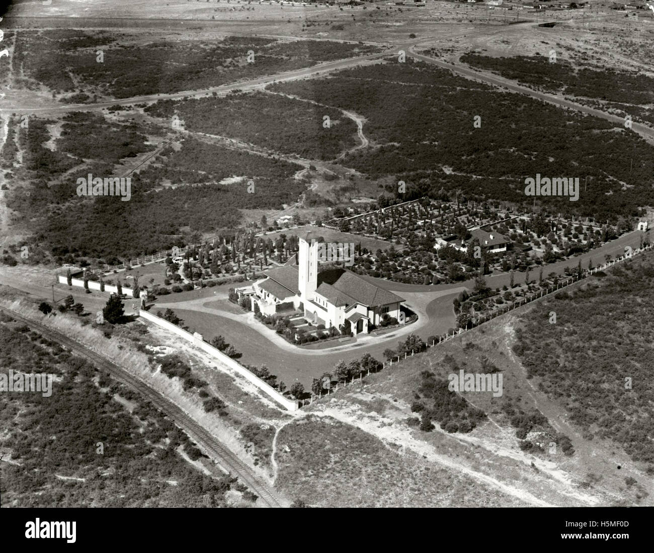 This image from the Adastra Aerial Survey Collection shows a crematorium, captured in 1938. The photograph provides a historical perspective on architectural and landscape design for such facilities during that period. Stock Photo