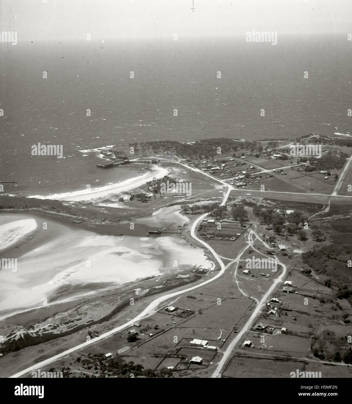 Aerial photograph of Bermagui taken on 17th November 1937 as part of the Adastra Aerial Survey Collection. This image captures the landscape of Bermagui, a coastal town in New South Wales, Australia. Stock Photo