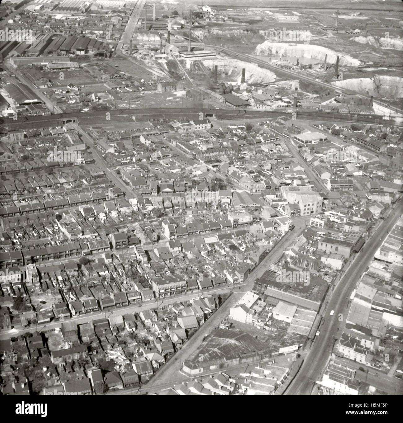 This aerial photograph taken on 25 August 1937 captures Erskineville and its surrounding areas. It is part of the 1937 Adastra Aerial Survey Collection and provides a historical view of the landscape, documenting the area for the Royal Australian Historical Society. Stock Photo