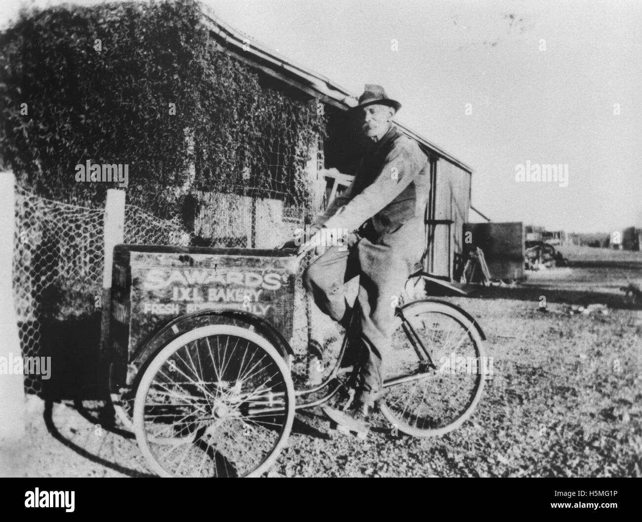 Bert Saward on his bread delivery bicycle in Boulia, ca Stock Photo