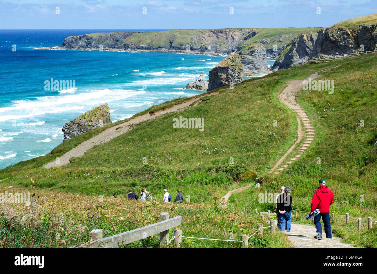People walking the southwest coastal footpath at Bedruthan, Cornwall, England, UK Stock Photo
