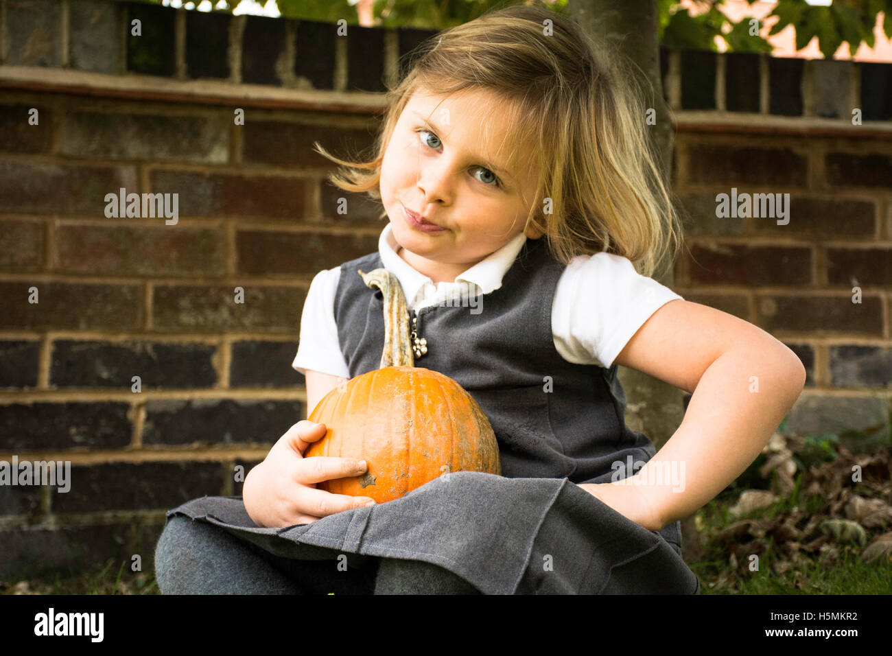 cute little girl holding pumpkin Stock Photo