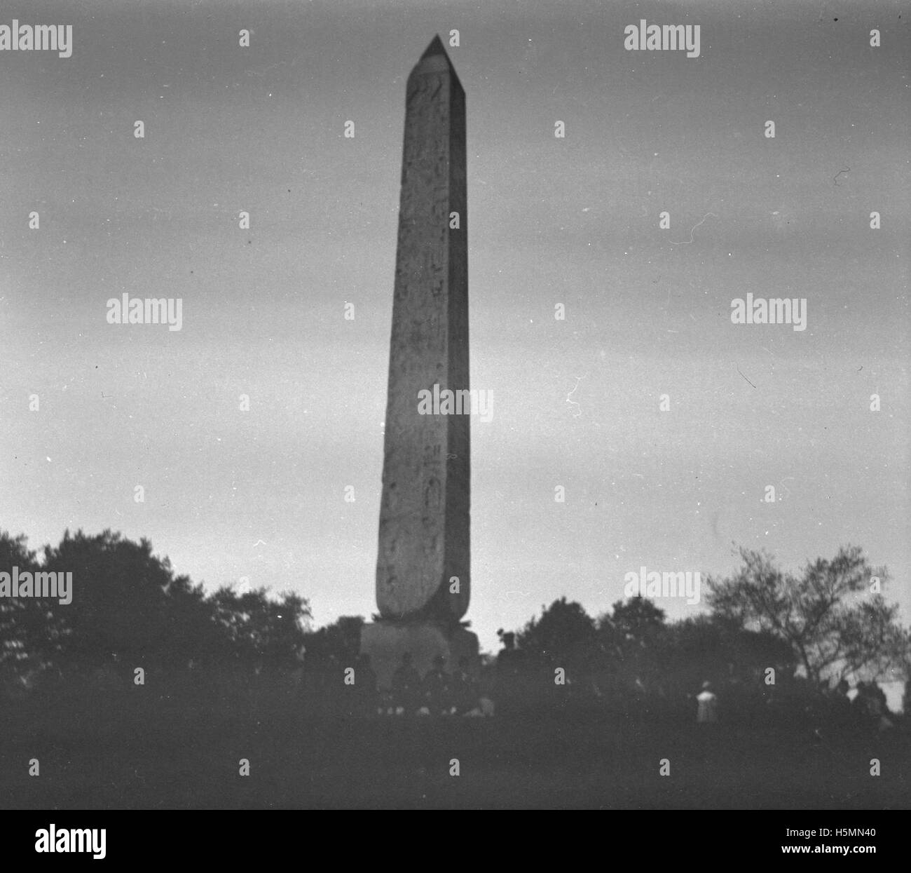 Cleopatra's Needle, an ancient Egyptian obelisk, was relocated to Central Park in New York in 1881. This photograph, taken on October 9, 1898, showcases the landmark in its iconic setting. The monument is a symbol of the ancient Egyptian influence in New York. Stock Photo
