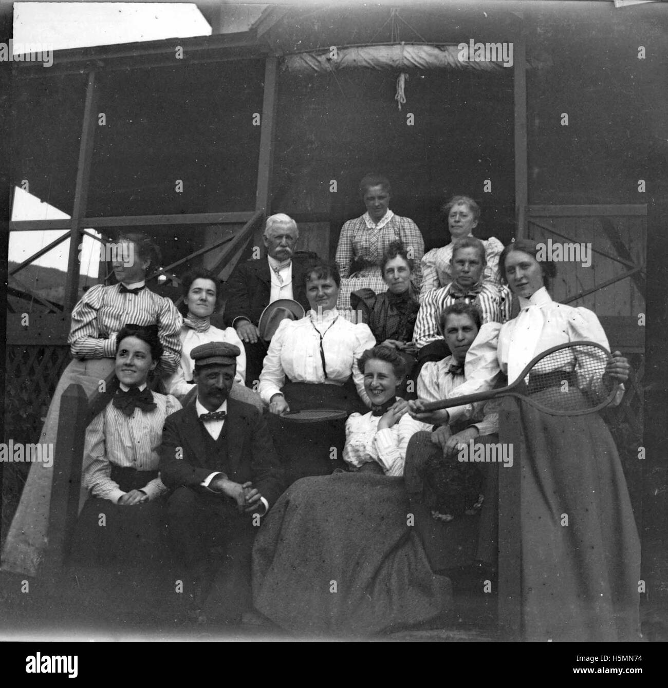 &quot;Camping crowd at Ogier Point, August 1900.&quot;  Theresa's sister Grace Parker is on the right with the tennis racket, and Father Brown is seated in back with white hair. Stock Photo