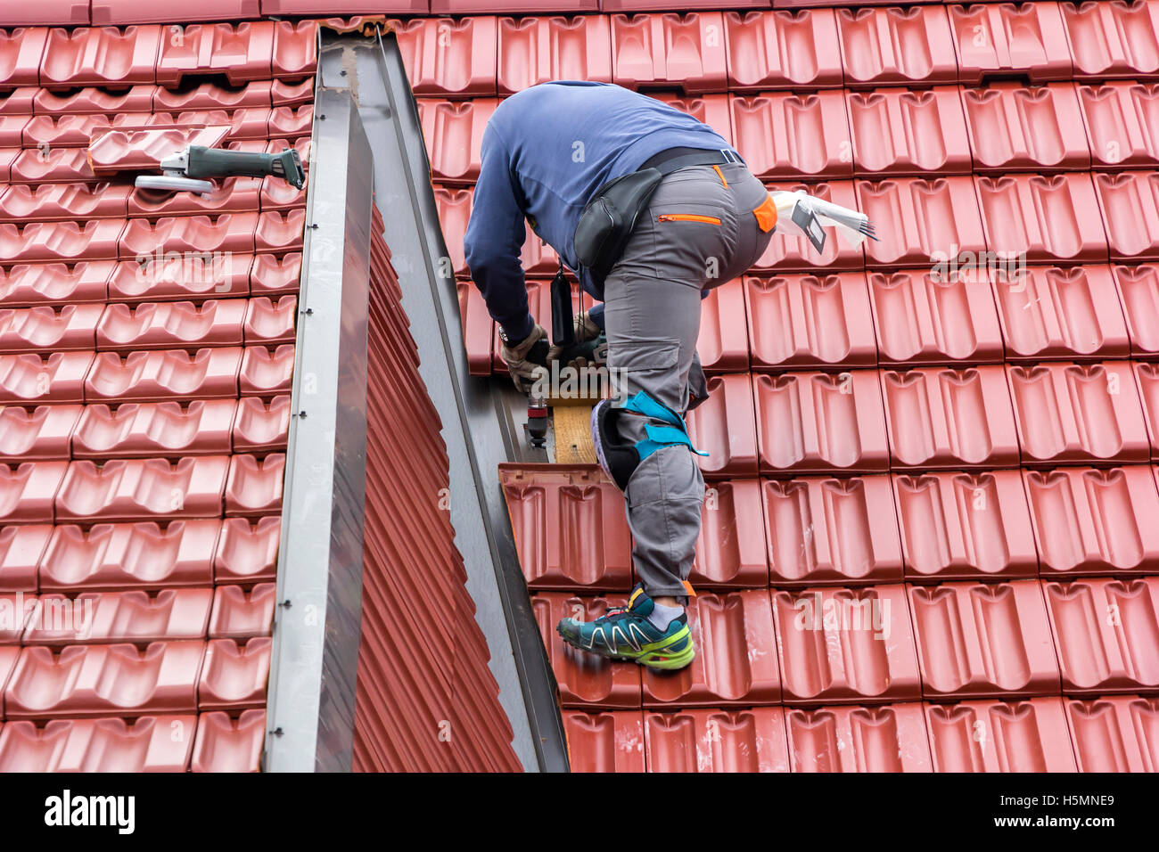 Roofer repair the roof of clay tiles Stock Photo Alamy