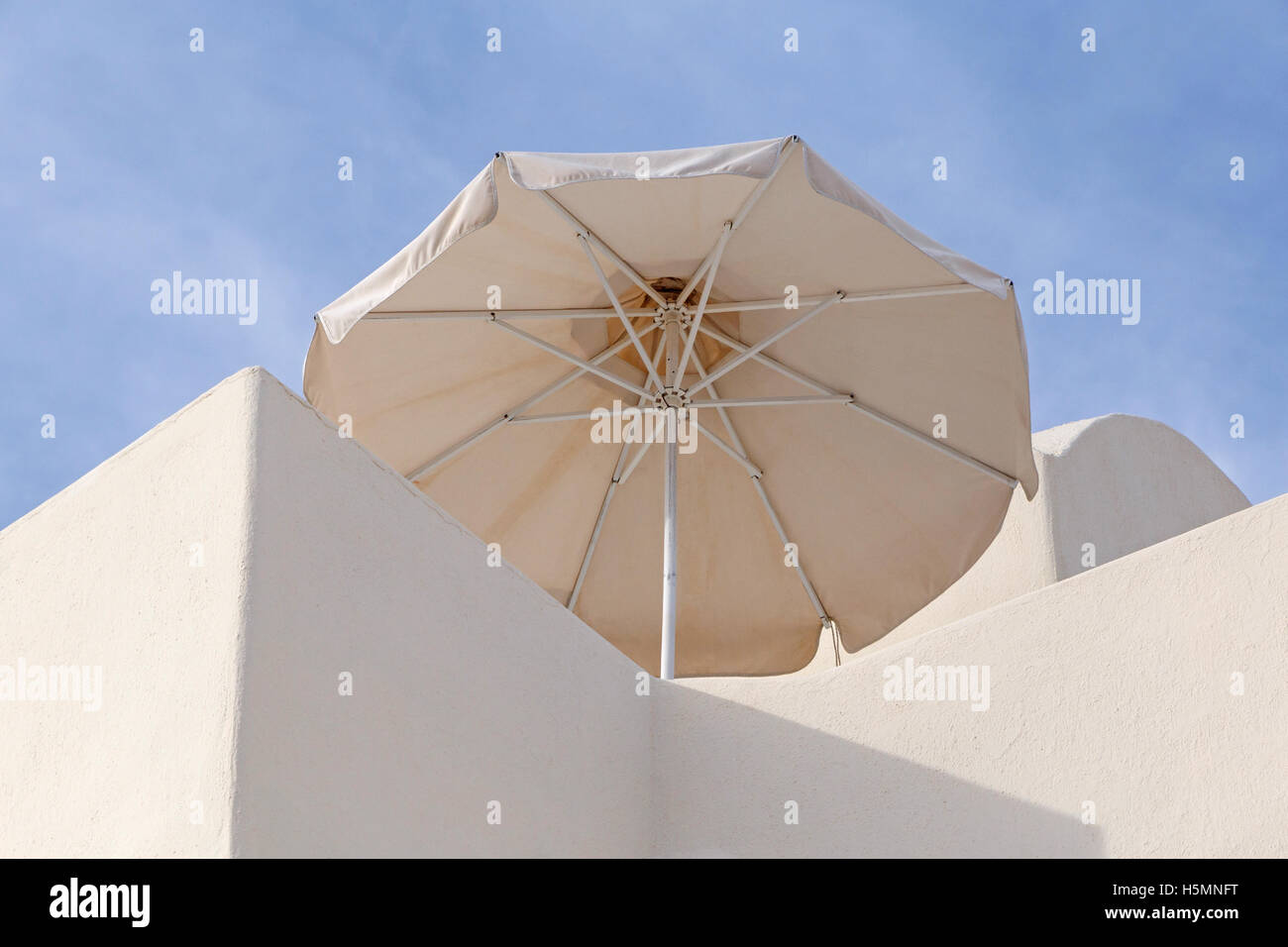 sunshade umbrella on balcony of traditional house in Oia on Santorini Stock Photo