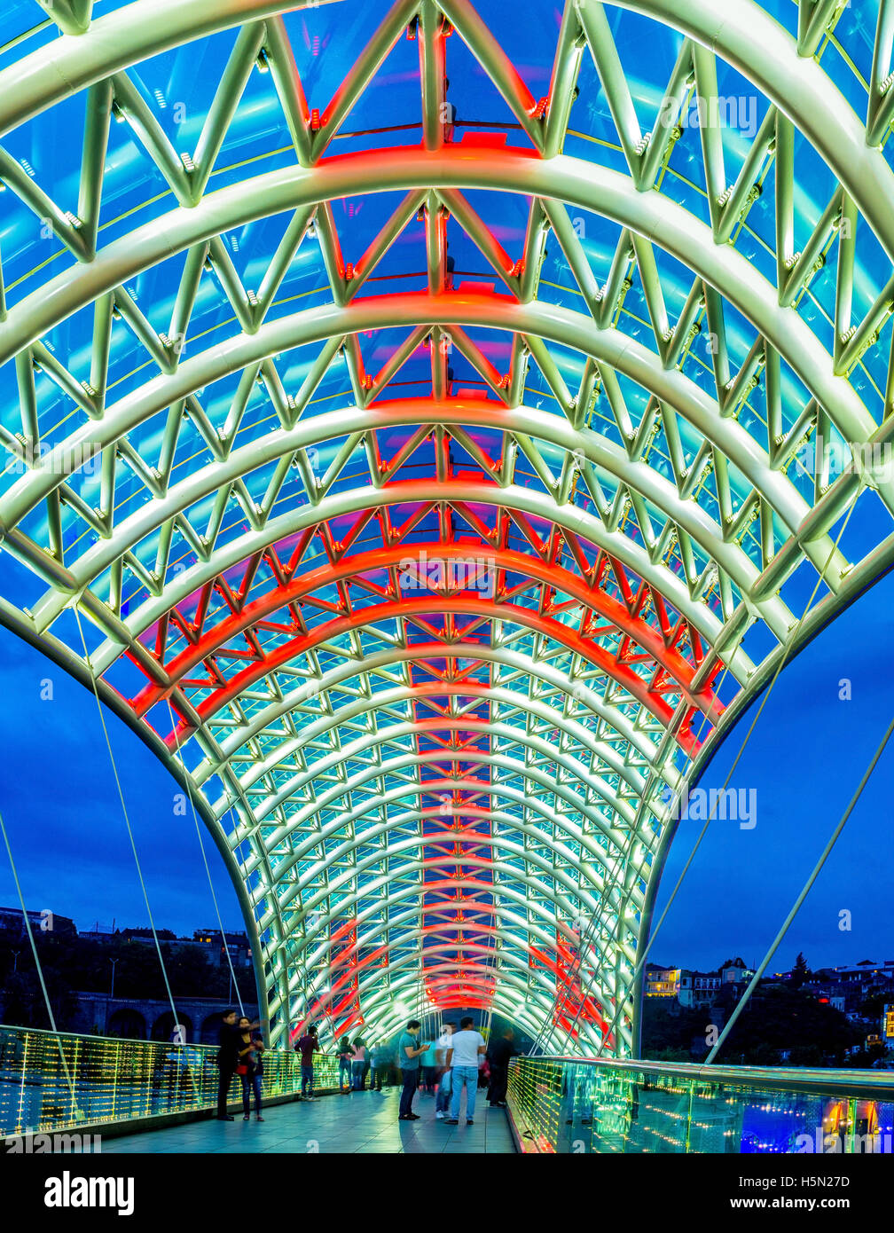 The glass tent of the Peace Bridge illuminated in colors of National Flag of Georgia Stock Photo