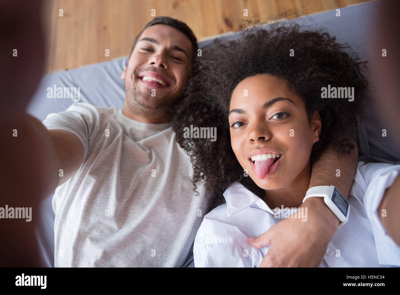 Funny couple putting our their tongues for photo Stock Photo