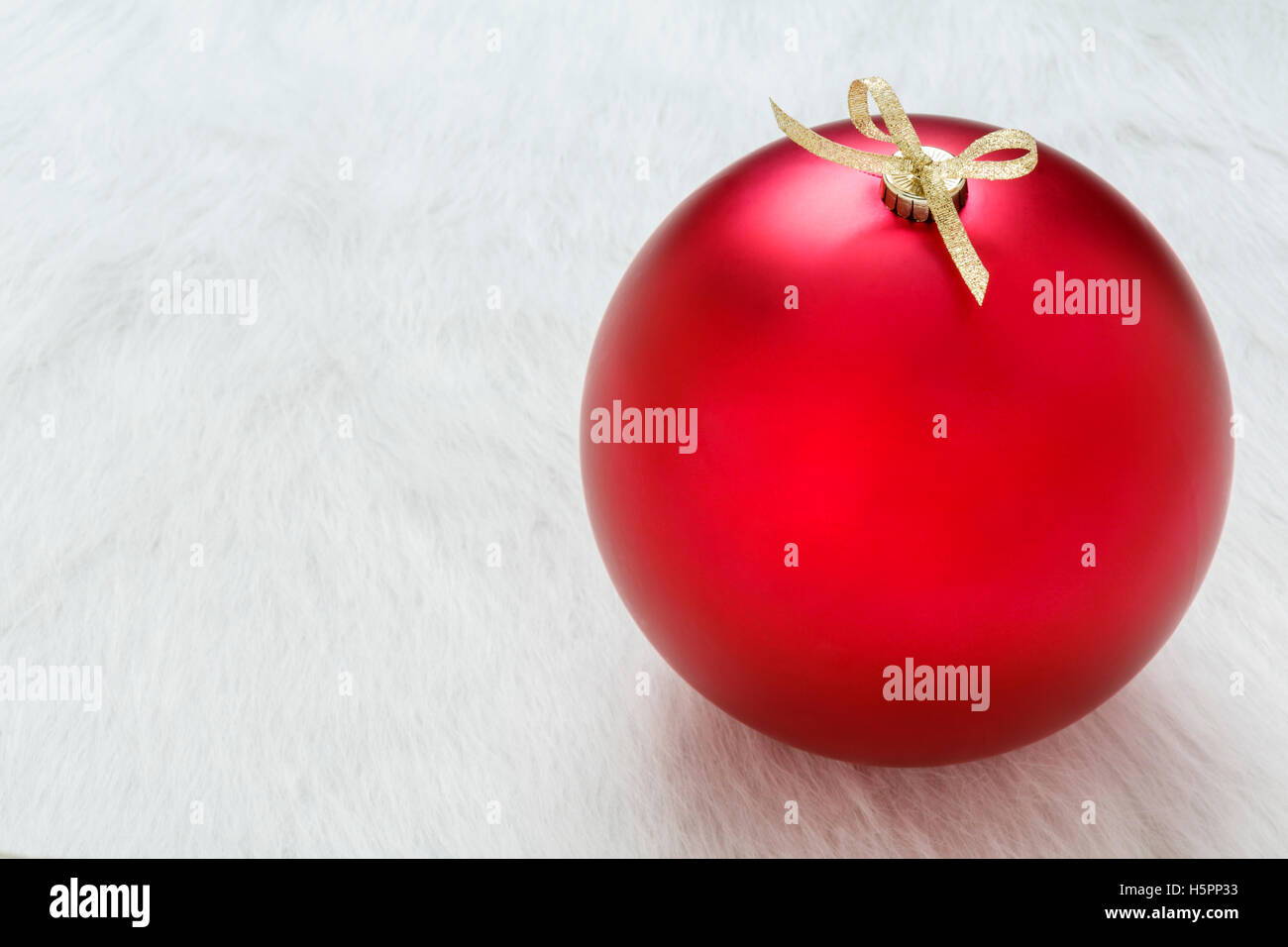 Close up of one perfect big red Christmas ornament on white background horizontal Stock Photo