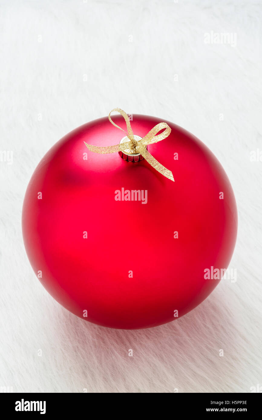 Close up of one perfect big red Christmas ornament on white background vertical Stock Photo