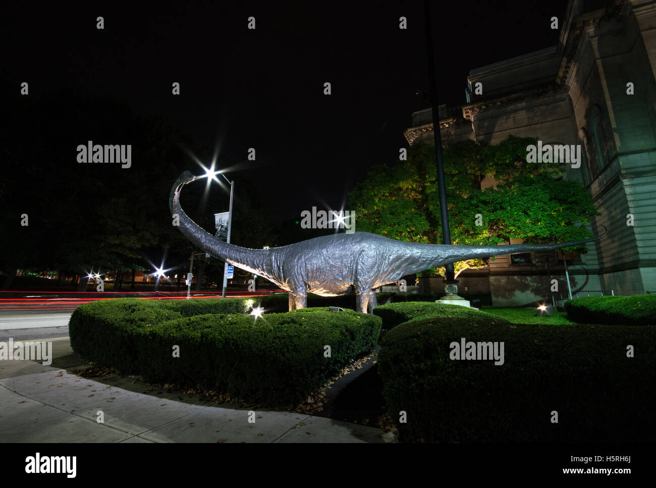 Dinosaur statue at night outside Carnegie Natural History Museum