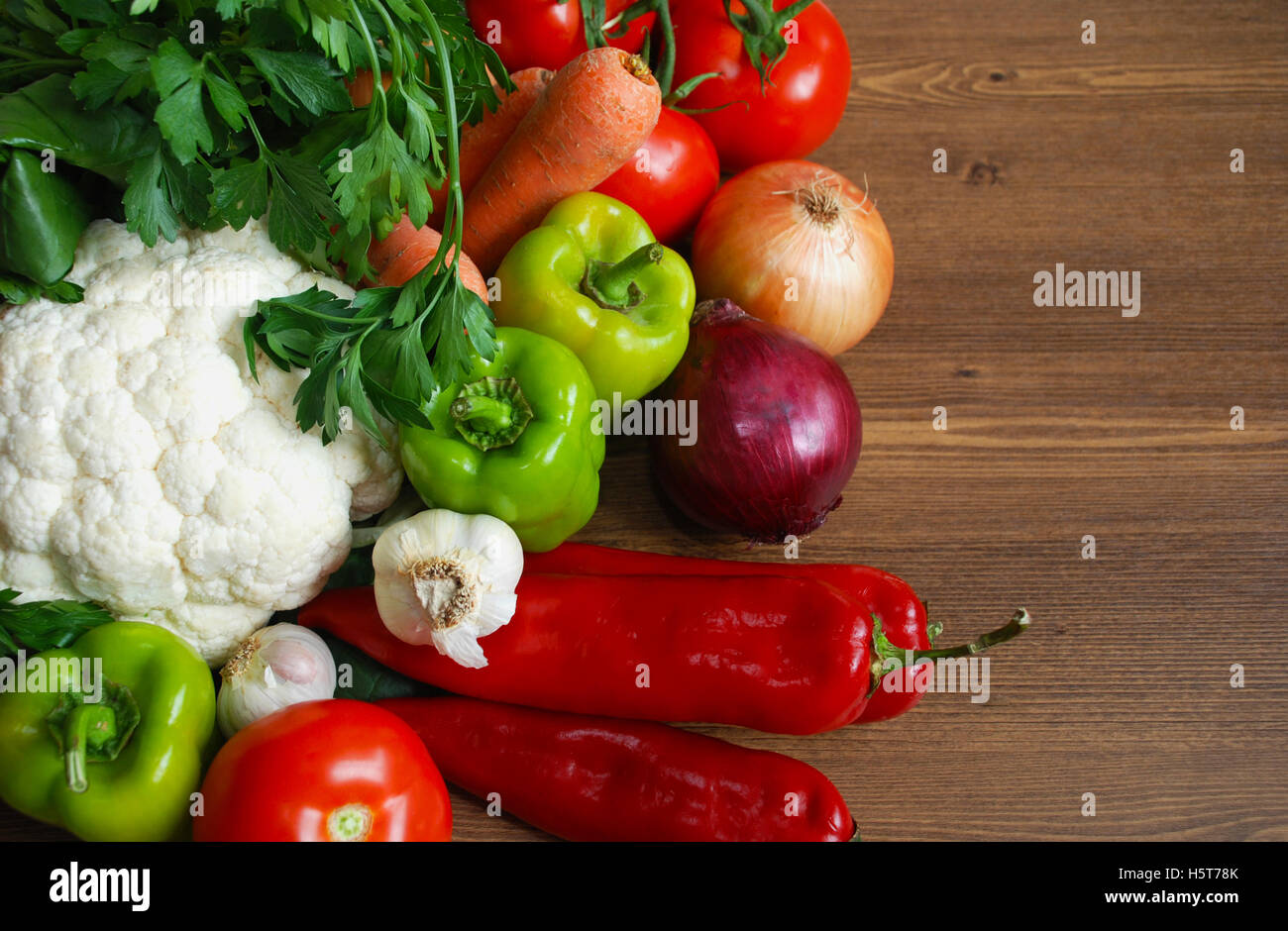 Healthy organic Assortment of fresh vegetables on dark wooden table. Stock Photo