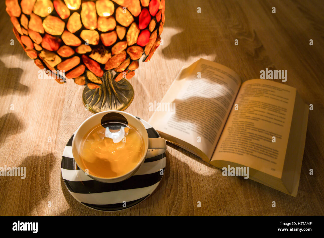 Reading with some tea Stock Photo - Alamy