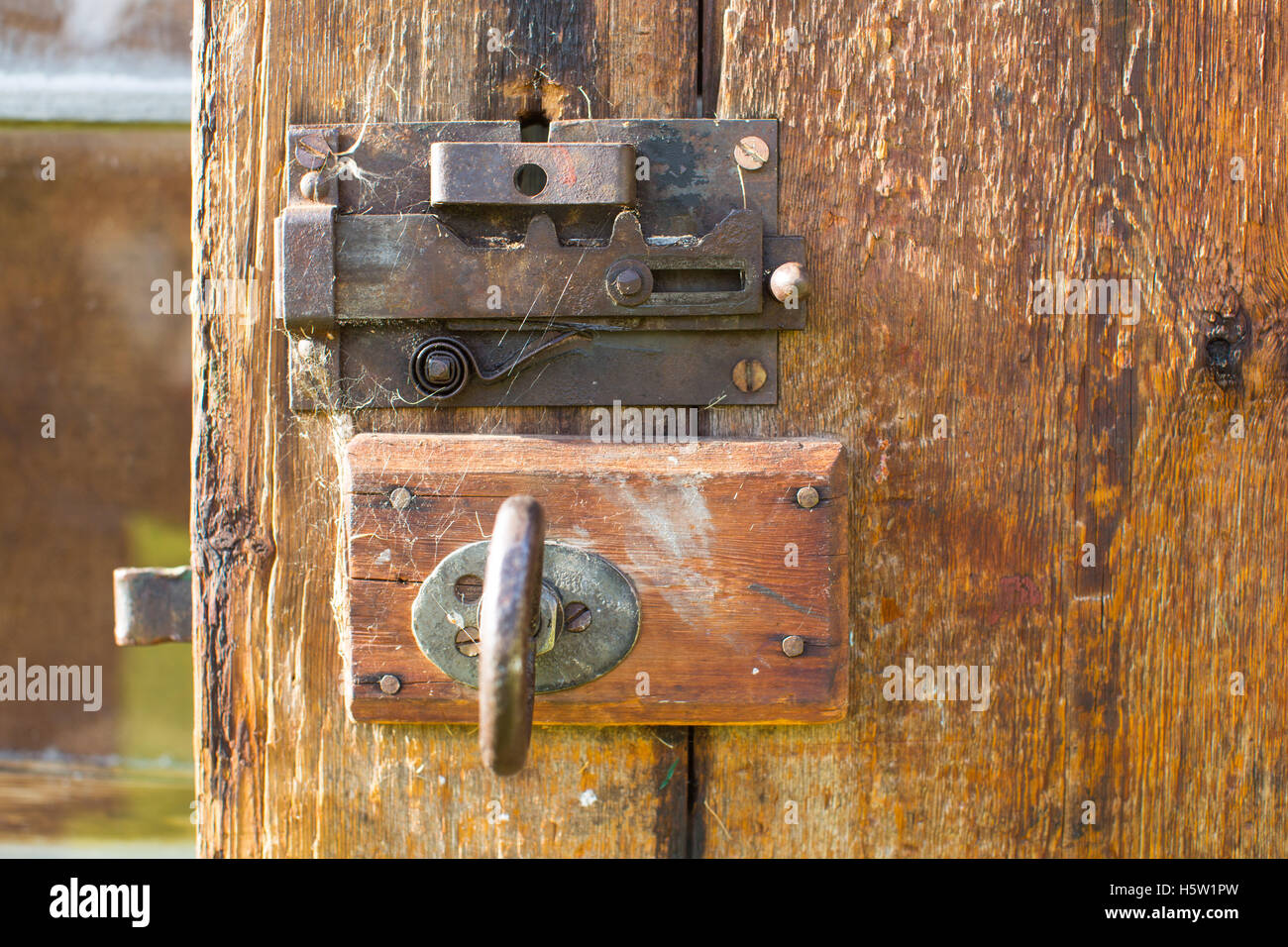 An old brown wooden door with an and old lock Stock Photo - Alamy