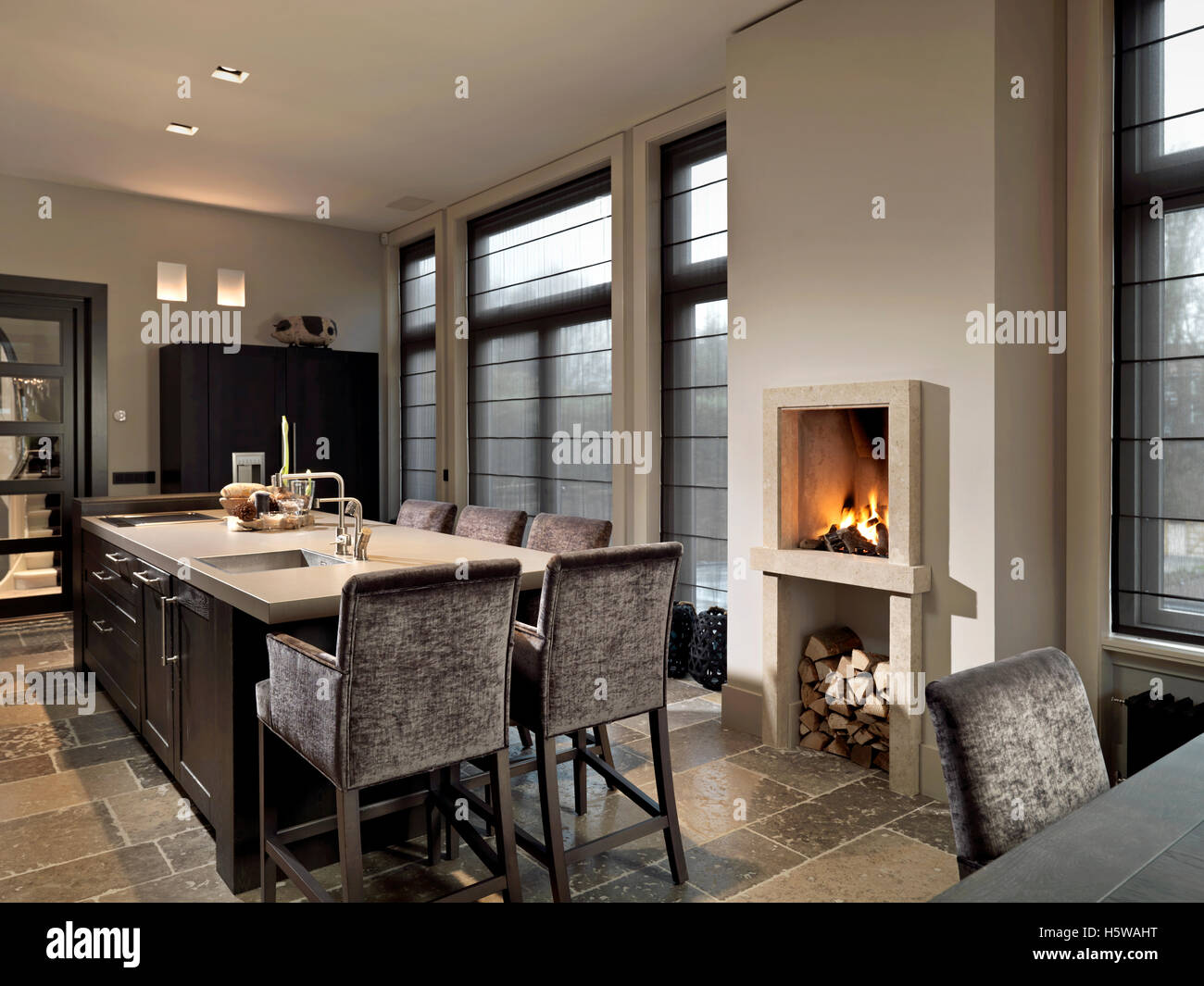 Fireplace in kitchen with table Stock Photo - Alamy