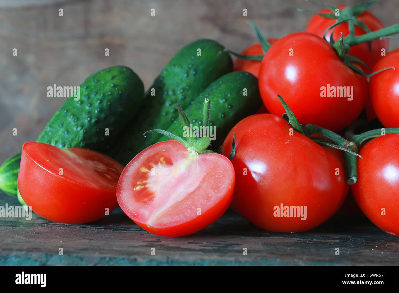 branch of tomatoes on wooden background Stock Photo - Alamy