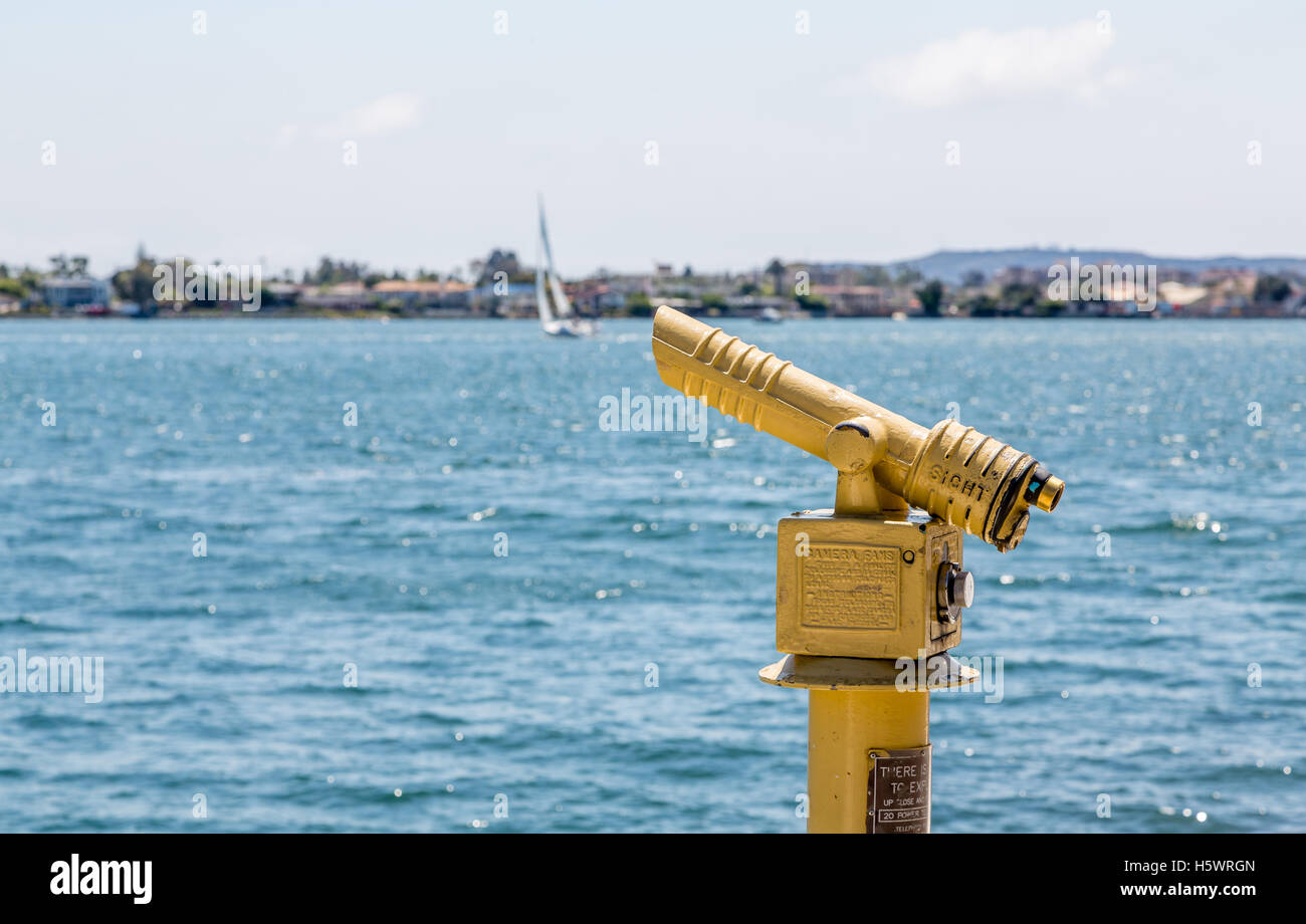 Yellow Spotting Scope over Blue Water Stock Photo