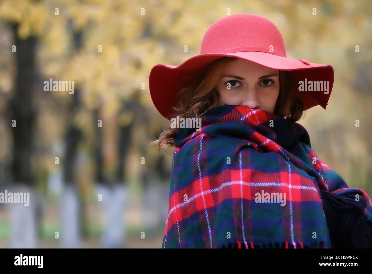 Serious woman in red hat in autumn park Stock Photo Alamy