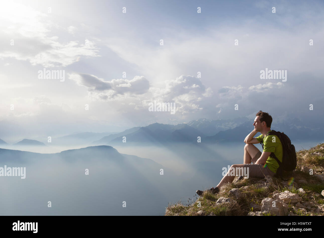 Hiker sitting to view beautiful landscape Stock Photo