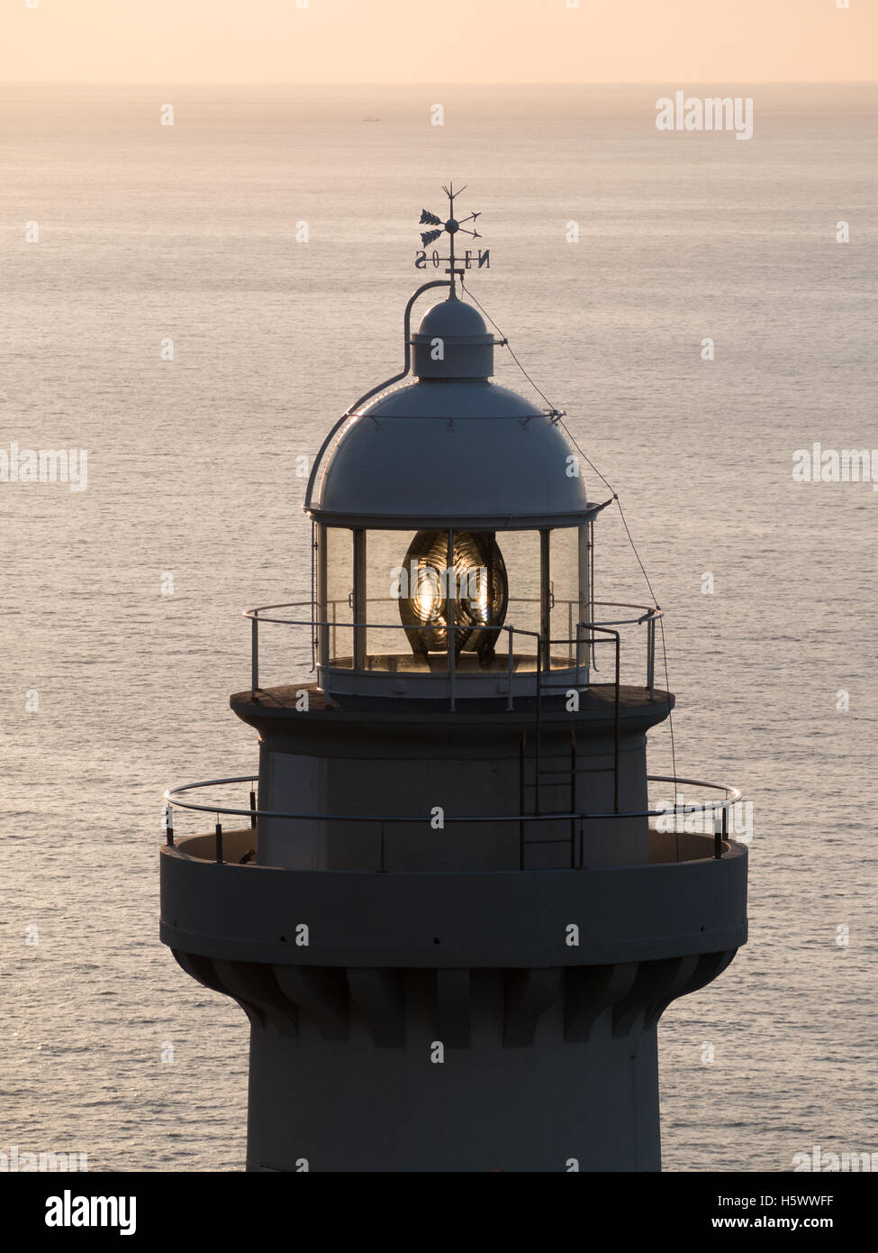 Lighthouse lantern with sea in background Stock Photo