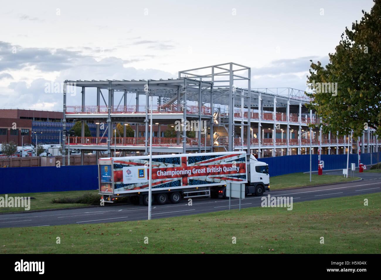 Aldi UK Headquarters in Atherstone, North Warwickshire. An Aldi  truck leaves the depot in front of the new Building extension. Stock Photo