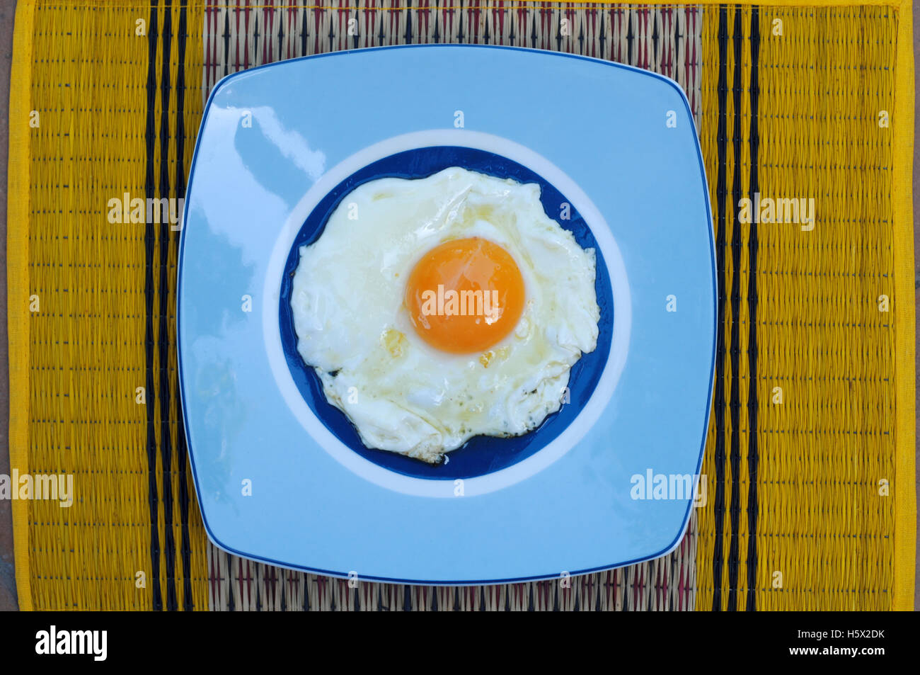 Directly Above Shot Of Sunny Side Up Egg In Blue Plate Stock Photo