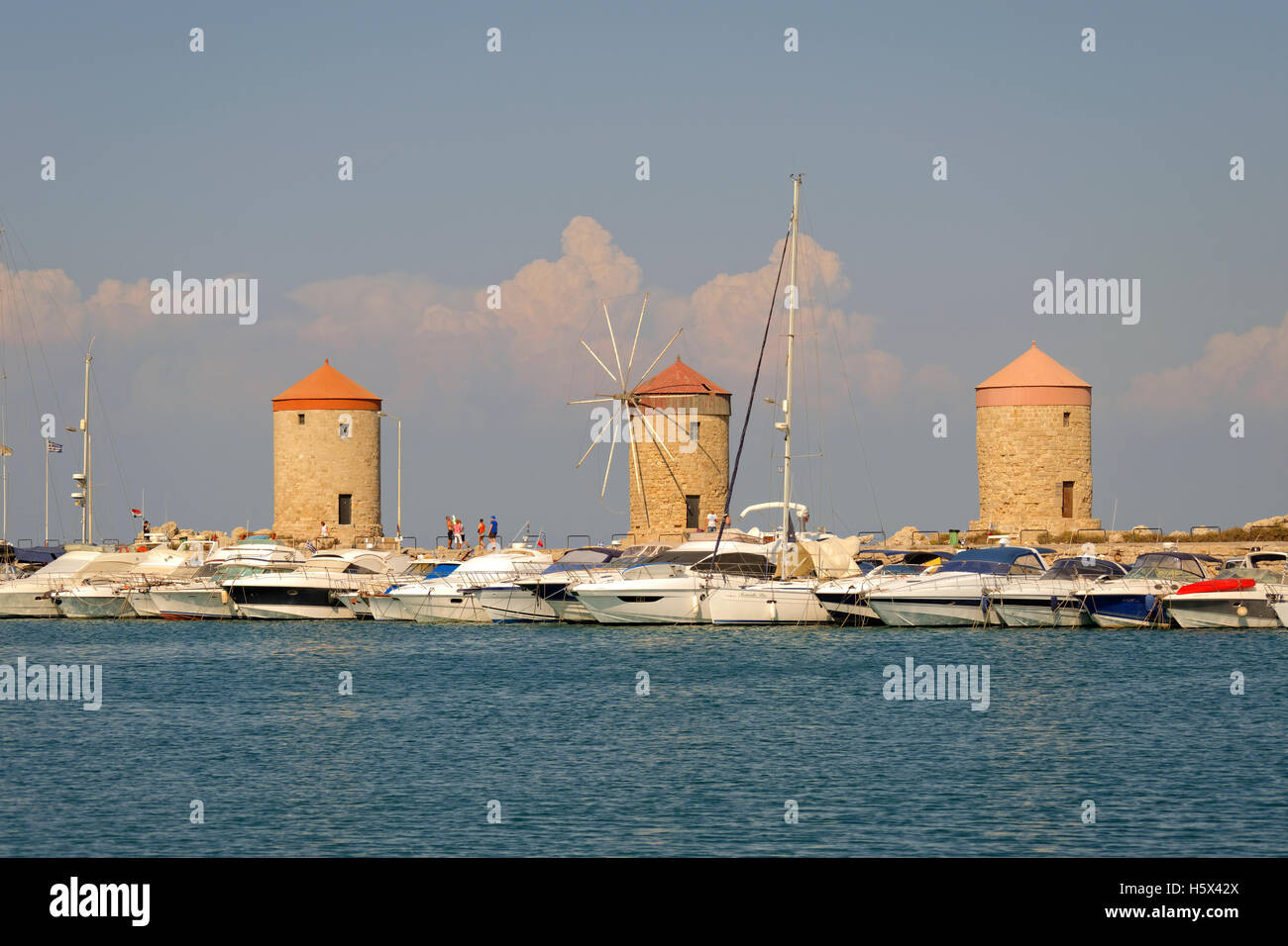 Old windmills at Rhodes city harbour, Island of Rhodes, Dodecanese island group, Greece. Stock Photo