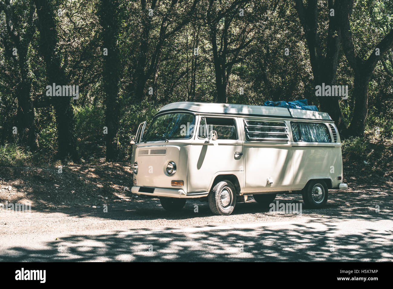 Vintage white bus camper on the road. Stock Photo