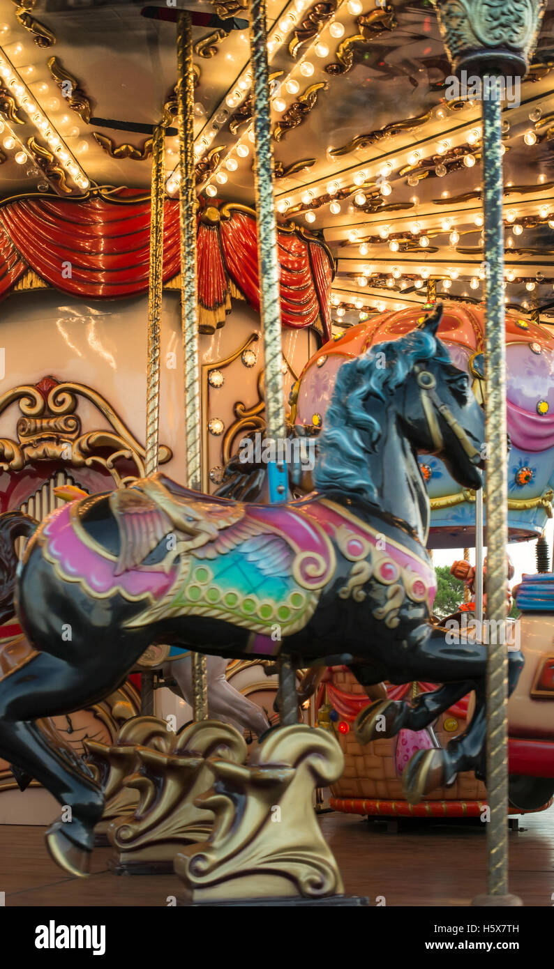 Carousel with horses in amusement park Stock Photo Alamy