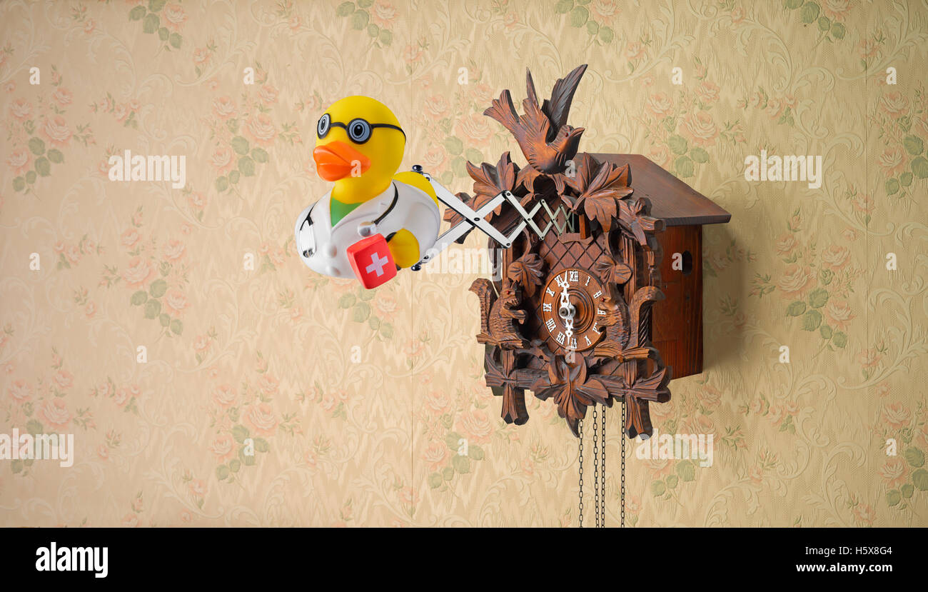 Doctor rubber duck coming out of cuckoo clock Stock Photo