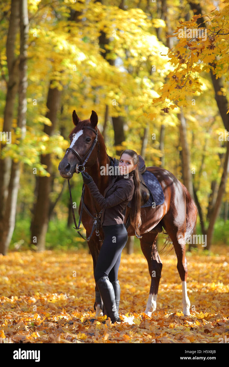 Equestrian model with her horse in autumn nature Stock Photo Alamy