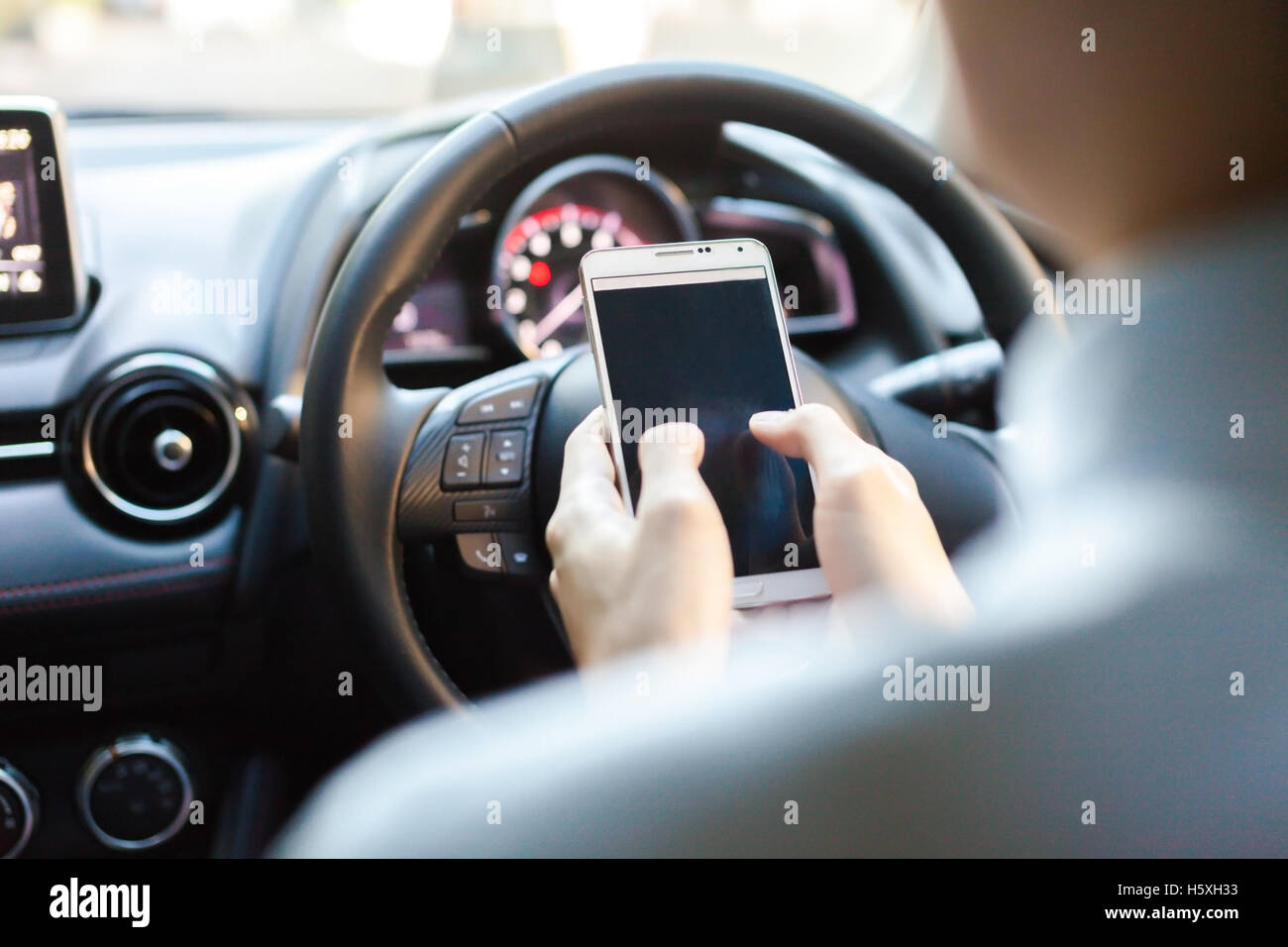 man using phone while driving the car (selective focus) - transportation and vehicle concept Stock Photo