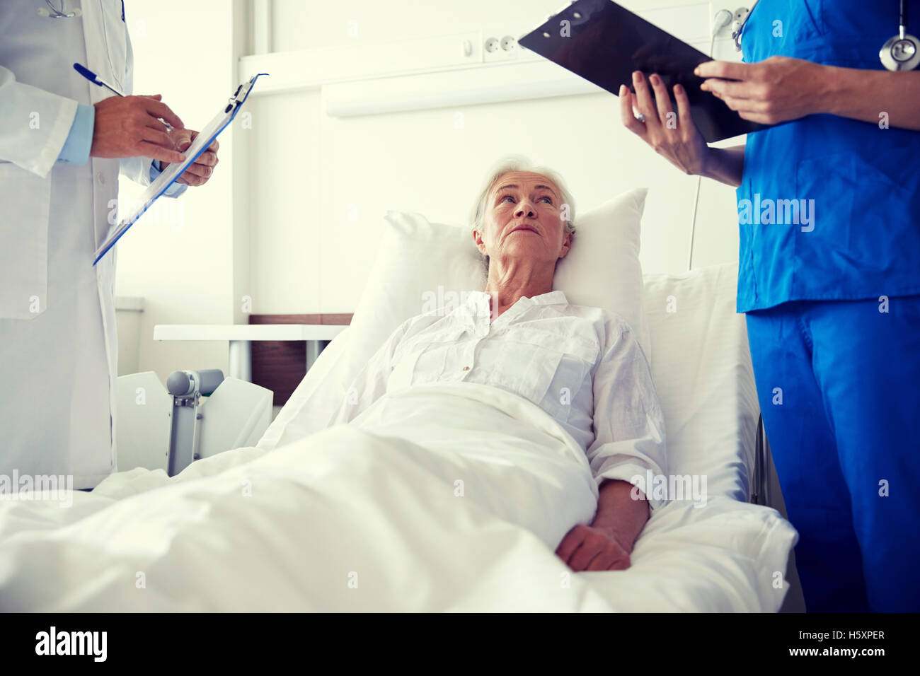 doctor and nurse visiting senior woman at hospital Stock Photo - Alamy