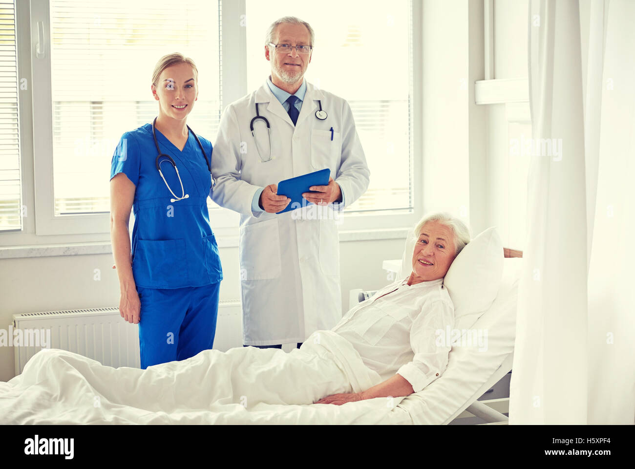 doctor and nurse visiting senior woman at hospital Stock Photo - Alamy