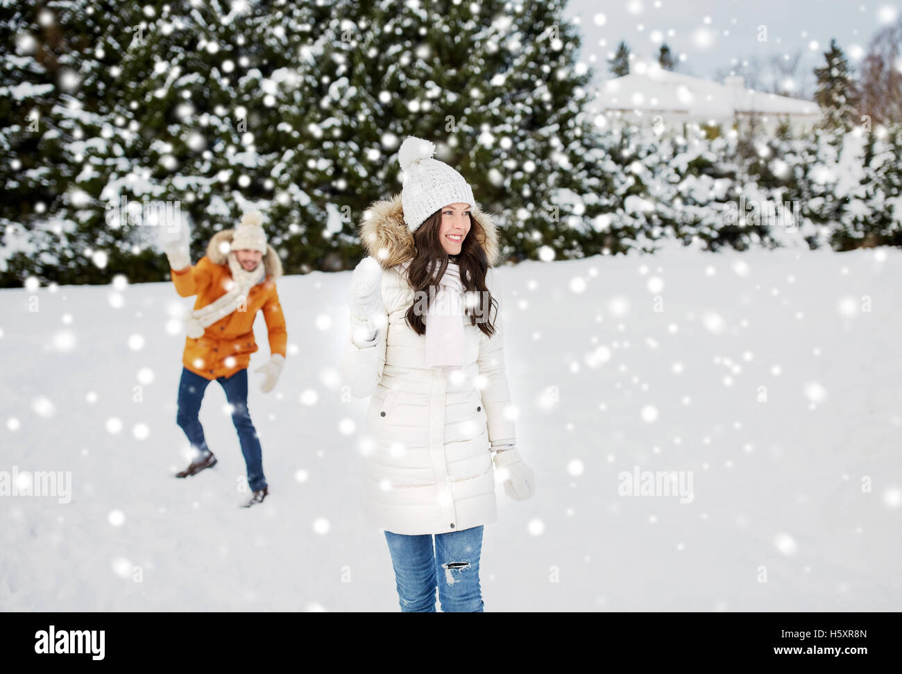 happy couple playing snowballs in winter Stock Photo - Alamy
