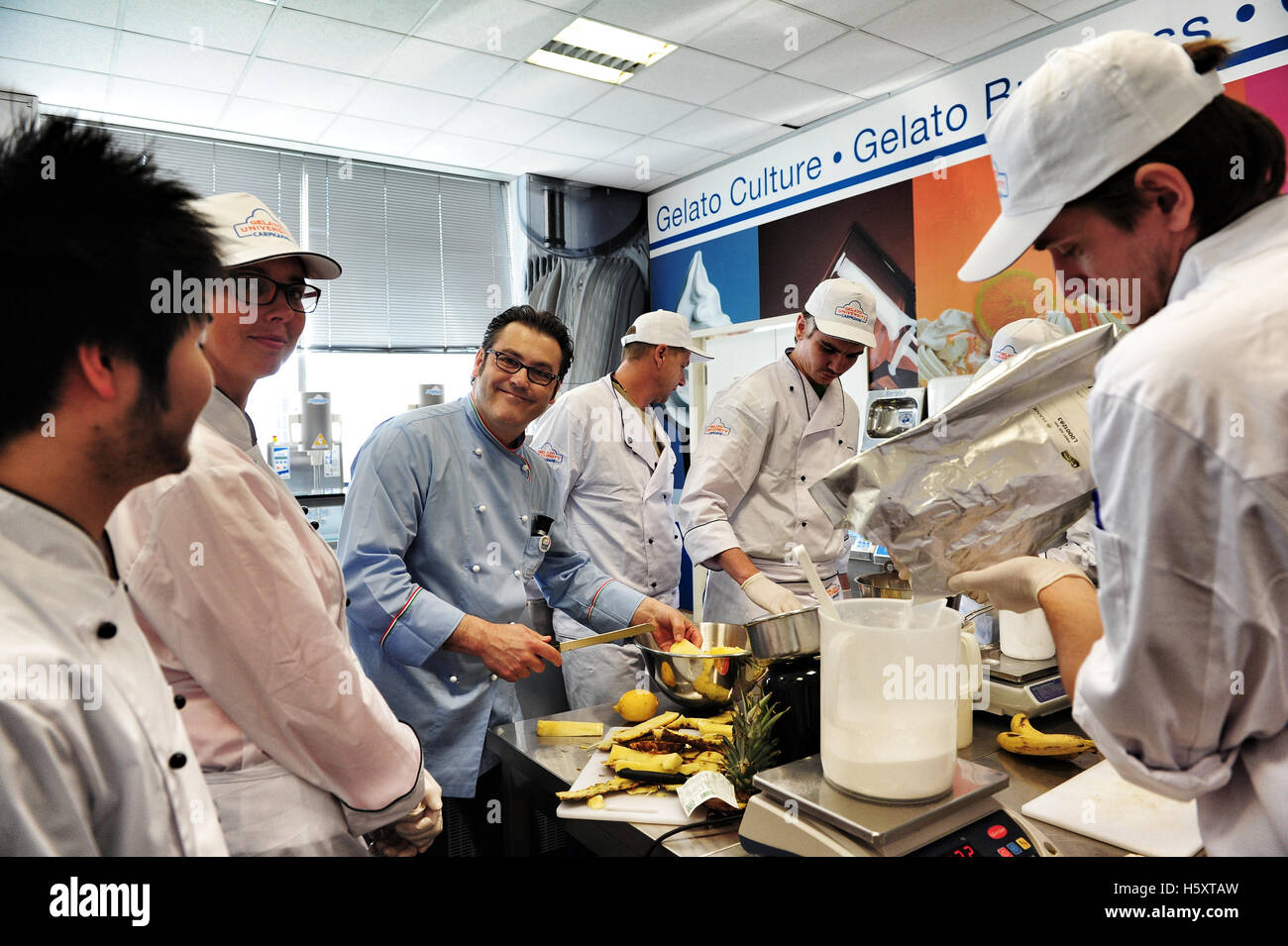 Maestro Palmiro Bruschi and his students during a practical lesson at the Carpigiani Gelato University in Italy Stock Photo