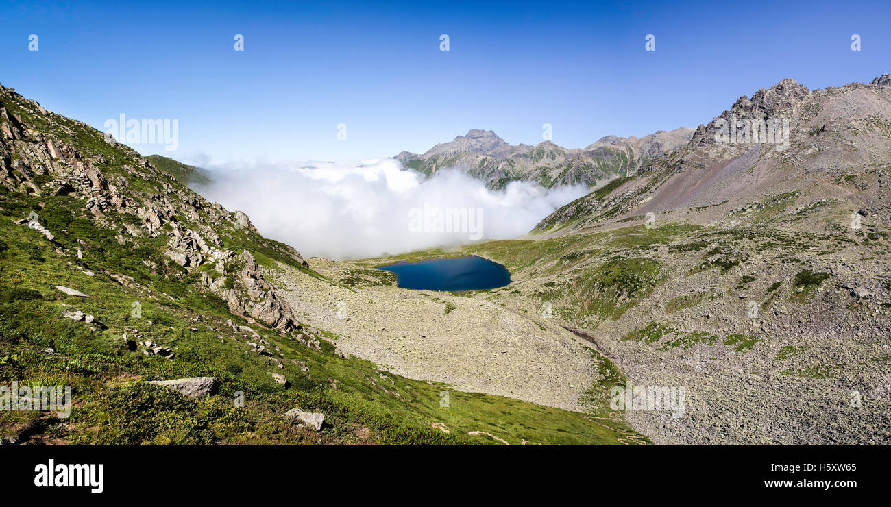 Panoramic view of glacial lake with foggy mountain background on the top of the Kackar Mountains or simply Kackars. Stock Photo