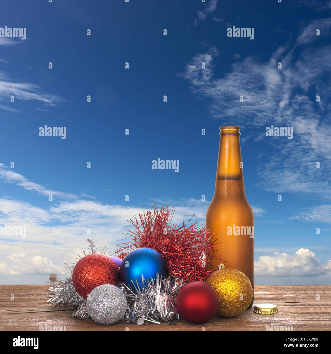 Cold beer Christmas in the sun. With tinsel. Stock Photo