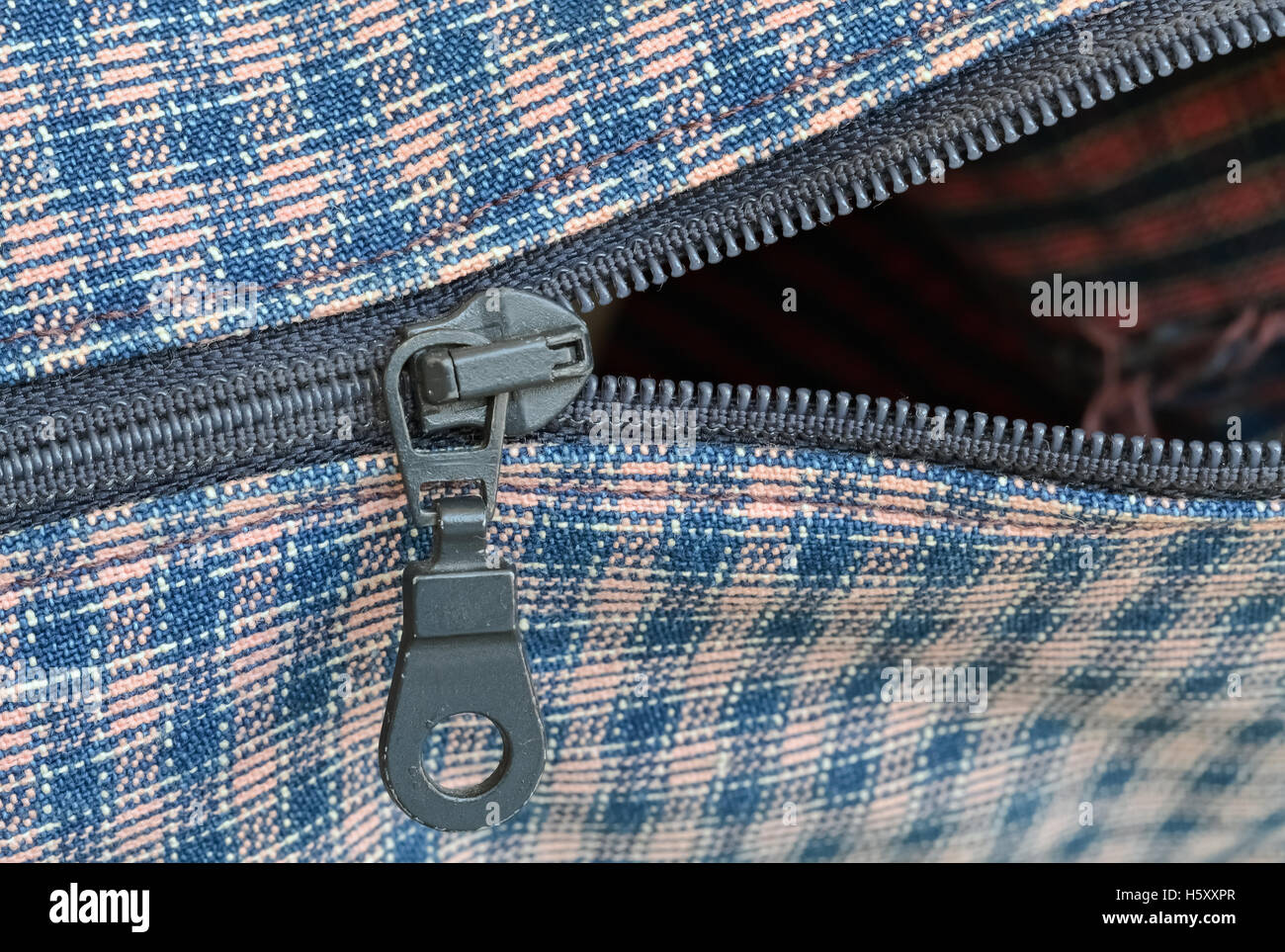Closeup of a metal zipper and plaid textile Stock Photo