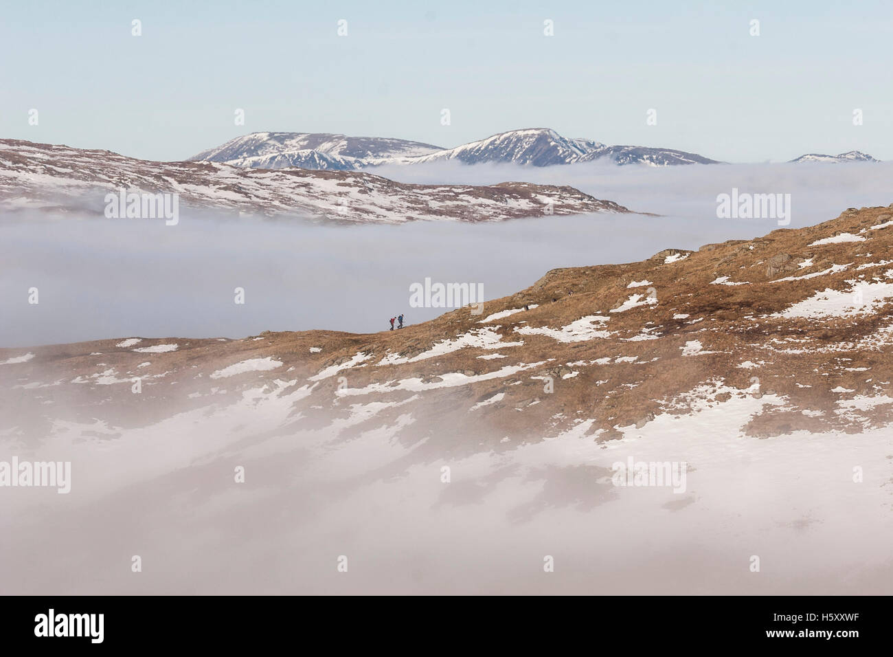 Two mountaineers walk out of a temperature inversion along Stone Arthur